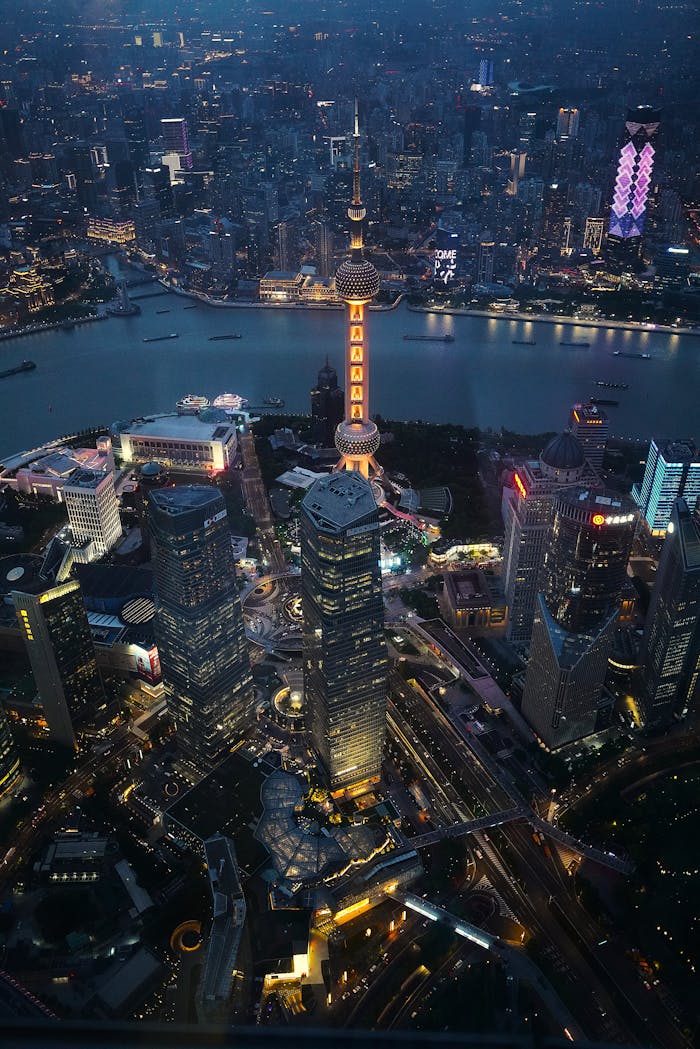 Stunning aerial view of Shanghai's illuminated skyline and the Huangpu River at night.